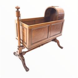 Victorian mahogany cradle on stand, the panelled crib with domed top section suspended from turned turned uprights united by double stretcher, raised on four splayed supports L115cm