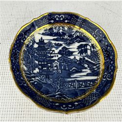 Pair of Caughley plates painted with the Chantilly Sprigs pattern c.1785, D18cm, Caughley shallow dish with the Pagoda pattern D21cm and a Caughley saucer dish with the Pagoda pattern, both with gilt highlights (4) 