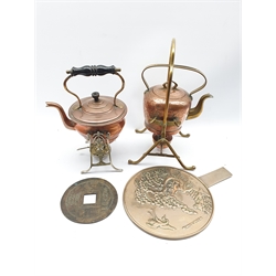 Two copper and brass spirit kettles, Japanese hand mirror and a large Chinese coin/token with central square shaped hole and Chinese symbols D15cm 