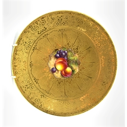Royal Worcester cabinet plate painted with a centre panel of peaches and grapes within a tooled and etched gilded ground signed 'Freeman' D23cm