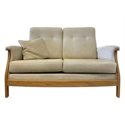Ercol - light elm framed two seat sofa upholstered in cream fabric (W152cm, H97cm, D87cm); and matching armchair (W97cm, H93cm, D97cm)