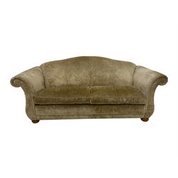 Large two seat sofa upholstered in champagne fabric, raised on bun feet