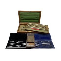 Early 20th century mahogany cased set of draughtsmen instruments, two other cased sets and a precision ground square