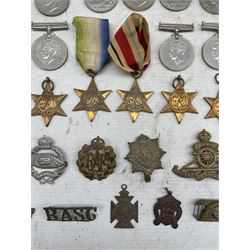 Two George VI Africa Stars, two 1939-1945 Stars, Italy Star, Atlantic Star, various WWII War and Defence medals, cap badges etc 