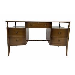 Mid 20th century mahogany serpentine front desk by 'Strongbow furniture', inset blue tooled skiver writing surface over five drawers, raised on splayed supports W137cm