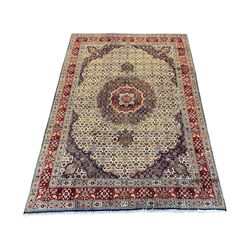 Persian Mood carpet, ivory, blue and red ground, large central medallion on Herati field, repeating guarded border decorated all over with stylised flower and plant motifs