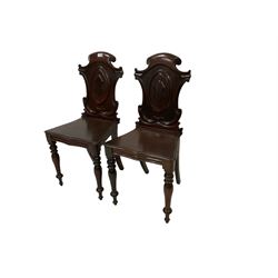 Pair 19th century mahogany hall chairs, carved shield-shaped scroll back raised on turned tapering front supports 