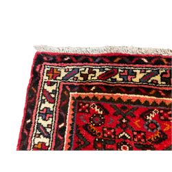 Large Persian Hosseinabad crimson ground runner rug, the field decorated with all-over geometric motifs, the multi-band ivory border with repeating stylised shapes