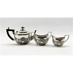 Edwardian bachelors silver three piece tea set of oval design with embossed decoration, the tea pot with blackwood handle and lift Birmingham 1902 Maker William Aitken14.3oz