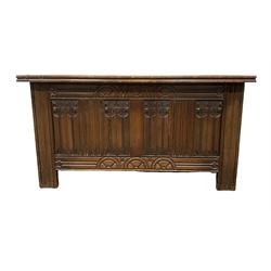 Strongbow Furniture oak blanket box of traditional design, the lifting top over linen carved base, raised on stile supports W99cm, H52cm, D40cm