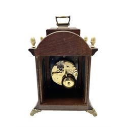  20th century miniature 8-day bracket clock - in a mahogany case with carrying handle, etched brass dial with a silvered chapter ring, Roman numerals and pierced brass hands, cherub spandrels and working rolling moon to the arch, Hermle floating balance movment strinking the hours and half-hours on two bells. 