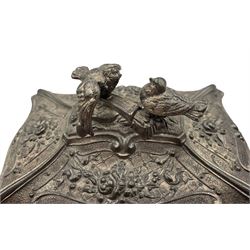 Early 20th century WMF silver-plated Britannia metal casket, of bombe form cast in relief with flowers and scrollwork, silk lined interior, dove finial and four scroll supports, L13cm