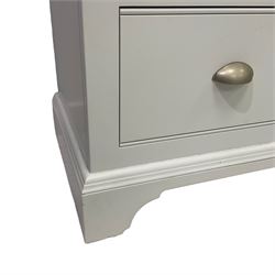 Contemporary white finish chest, fitted with two short over two long drawers, raised on plinth base