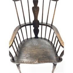 Early 20th century dark oak Windsor style armchair, with spindle back and floral carved splat and swept arms, saddle seat, raised on ring turned supports united by double 'H' stretcher, W71cm
