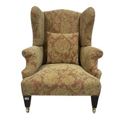 Georgian style armchair, upholstered in floral fabric, raised on square tapering supports, terminating in brass castors 