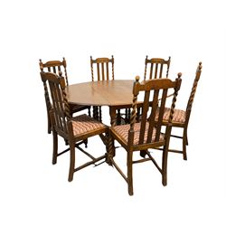 Early 20th century oak drop leaf table, the oval top raised on spiral turned supports with gate leg action, (W107cm) together with a set of six stained beech dining chairs, with moulded slat and spiral turned back over drop in upholstered seat pads, raised on spiral turned supports with stretchers W45cm