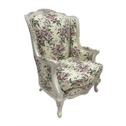 Louis XV style armchair, the carved cresting rail, wings, and supports with foliate design, upholstered in pink and green floral Sanderson fabric 1993 