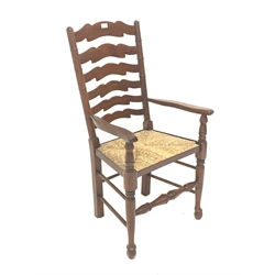 Late 20th century mahogany farmhouse style carver armchair, waved ladder back and rush seat, total width - 56cm