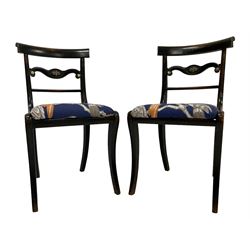 Pair of early Regency lacquered mahogany chairs, centre rail with gilt metal cornucopia mount, seat upholstered in aviary marine fabric, raised on sabre supports