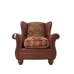 Tetrad - 'Eastwood' wingback armchair, upholstered in buffalo hide leather with studwork, with Kilim chenille loose cushions, raised on turned feet