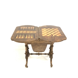 Victorian figured walnut fold over games table, with floral string inlay to top over revolving top revealing inlaid chess and cribbage boards, over one drawer and hanging storage slide, raised on turned columns and scrolled supports terminating in castors, W64cm, H73cm, D43cm