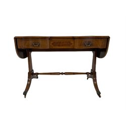 20th century quality mahogany sofa table, the drop leaf top over three frieze drawers, raised on four splayed supports, terminating in brass hairy paw castors 
