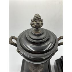 Pair of Victorian Classical black slate garnitures, each of urn form with bronze finial, handles and pedestal base, on square stepped bases, H30.5cm
