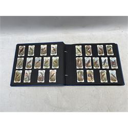 An album of cigarette cards including Ogdens Boxers 1915, full set of 50, Wills Military Motors (50), Wills Mining (50) and other sets and part sets