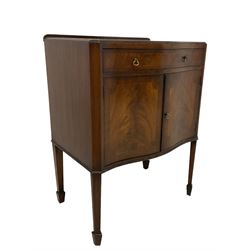 Early 20th century mahogany serpentine side cabinet, fitted with single drawer over two cupboard doors, each crossbanded with boxwood stringing, flanked by canted corners, raised on tapering supports with spade feet
