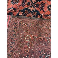 Tekke Turkoman rug of of geometric and stylised floral design, on a red field with multi-stripe border 