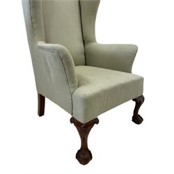 Queen Anne design hardwood framed wingback armchair, upholstered in sage green fabric, on shell carved ball and claw feet