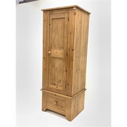 Narrow pine single wardrobe, panelled door enclosing interior fitted with hanging rail, over drawer, skirted base, W70cm, H187cm, D57cm