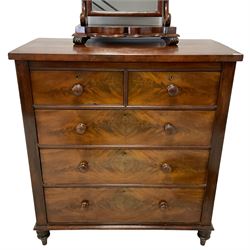 Victorian mahogany straight-front chest, fitted with two short over three long graduating drawers, raised on turned feet (W110cm D58cm H121cm); and a Victorian mahogany dressing table mirror, rectangular plate on scrolled swing supports, shaped platform base (W62cm H69cm)