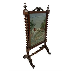20th century mahogany fire screen, the central panel with equestrian design, flanked by two spiral turned columns, terminating in brass castors  