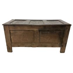 18th century oak coffer or chest, rectangular triple-panelled hinged top, the frieze carved with repeating leaf motifs in the form of flattened gadroons, over panels carved with concentric lozenges with central flower heads, on stile supports