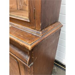 Victorian scumbled pine bookcase on cupboard, projecting cornice over two glazed doors enclosing two shelves, cushion fronted frieze drawer and double to base W105cm