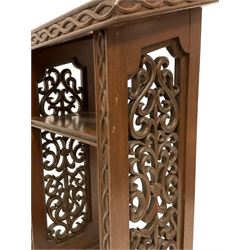 19th century walnut lectern, the sloped top with raised lip and interlacing edge decoration, the sides with pierced and carved scrolling foliate panels, fitted with single shelf, on stepped and moulded sledge feet with beaded decoration 