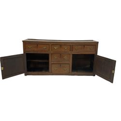 Georgian oak dresser base, the rectangular top over three long and two short drawers with chequered inlay, flanked by two cupboards