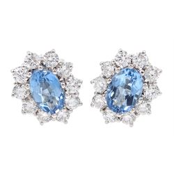 Pair of 18ct white gold oval aquamarine and round brilliant cut diamond cluster stud earrings, stamped 750, total aquamarine weight approx 1.55 carat, total diamond weight approx 0.90 carat