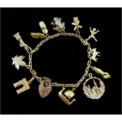 14ct gold link bracelet with 9ct gold heart locket clasp, two 18ct column arch and Viking boat charms, eight 14ct gold Statue of Liberty, leaf, pair of clogs, windmill, reindeer, figure, hand and city charms and a 9ct gold frog charm, all stamped, hallmarked or tested
