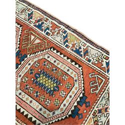 Turkish orange ground rug, two medallions decorated with geometric motifs, geometric design border