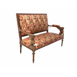 Victorian walnut settee, the rectangular back and seat upholstered in red and gold coloured fabric, show rail carved with repeating floral motif, open arms with seraph carved arm terminals, raised on turned and fluted supports  W140cm