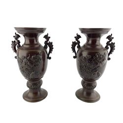 Pair of 20th century Japanese patinated bronze twin-handled vases, each decorated in relief with peonies and birds, H26cm 