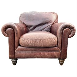 Single armchair upholstered in brown leather, traditional shape with rolled arms, on turned feet
