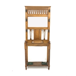  Early 20th century Arts and Crafts light oak hall stand, with six cast metal coat hooks enclosing bevelled mirror and pierced decoration, hinged trinket box over two stick stands, ring turned front supports, W76cm  