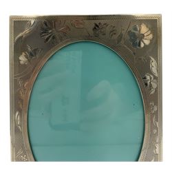 Tiffany & Co silver photograph frame with oval aperture and engraved with flowers, aperture size 13cm x 10cm Sheffield 1998