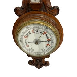 Early 20th century carved oak aneroid barometer - profusely carved top and base with a mercury thermometer and porcelain register recording barometric air pressure from 26 to 31 inches, with a steel indicating hand and brass recording hand within a brass bezel and flat glass.