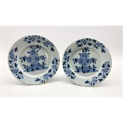 Pair of 18th century Delft tin-glazed plates decorated with a fence and flowers, within a floral border, D22.5cm 