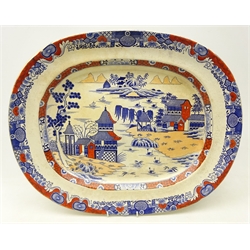 19th century Masons Ironstone china meat plate decorated with pagodas within a river landscape, with underglaze blue and iron red painted decoration, L49cm