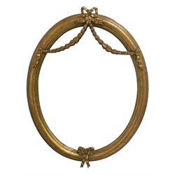 Victorian design oval wall mirror, in a moulded frame decorated with ribbon ties and foliate festoons, plain mirror plate